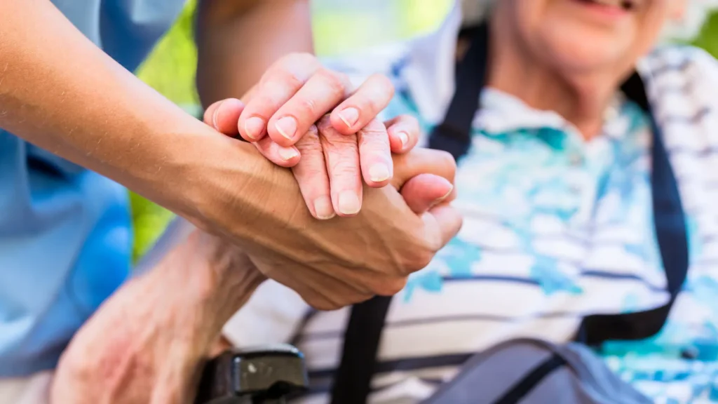 carer holding hands
